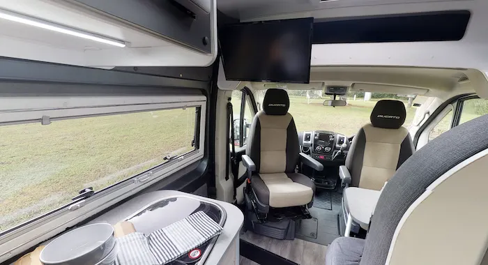 Interior view of Avida Escape campervan looking from the back area into the drivers seat