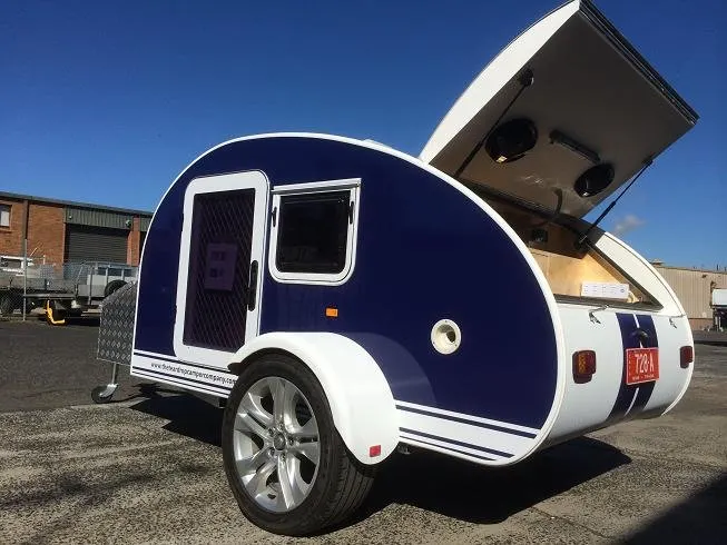 blue teardrop camper with the kitchen open