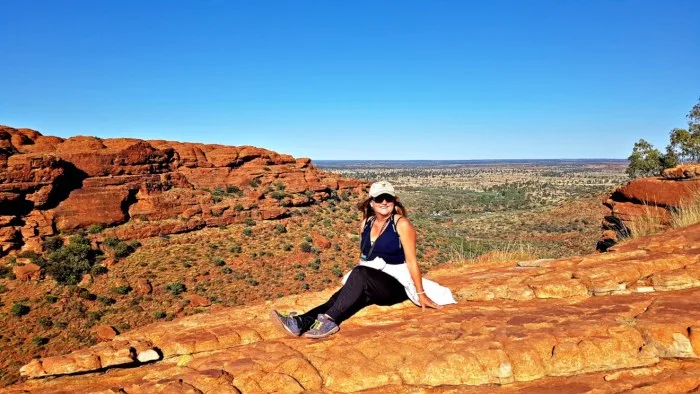 Woman sitting on a rock at Kings Canyon, NT, Australia
