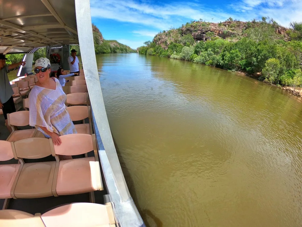 Woman standing on a tour boat on a river in Northern Territory, Australia