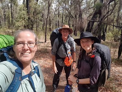 Family of 3 with hiking packs, on the Bibbulmun Track, Australia.