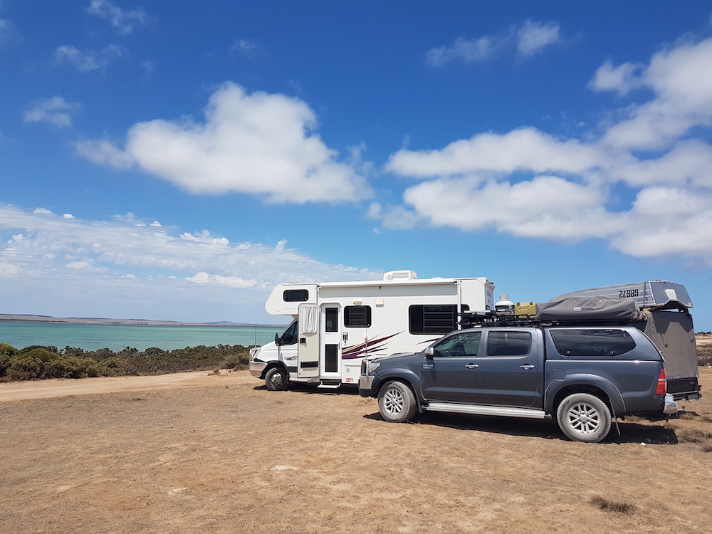 Motorhome and ute parked at the beach in Australia.