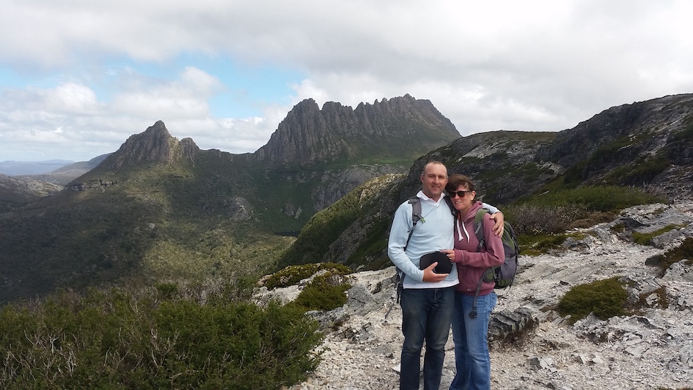 Couple standing in front of Cradle Mountain, Tasmania, Australia