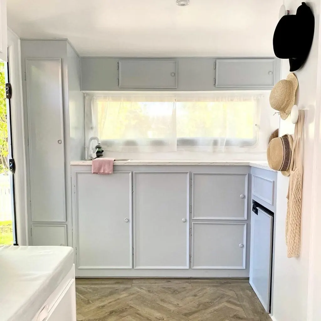 White kitchen in a renovated caravan