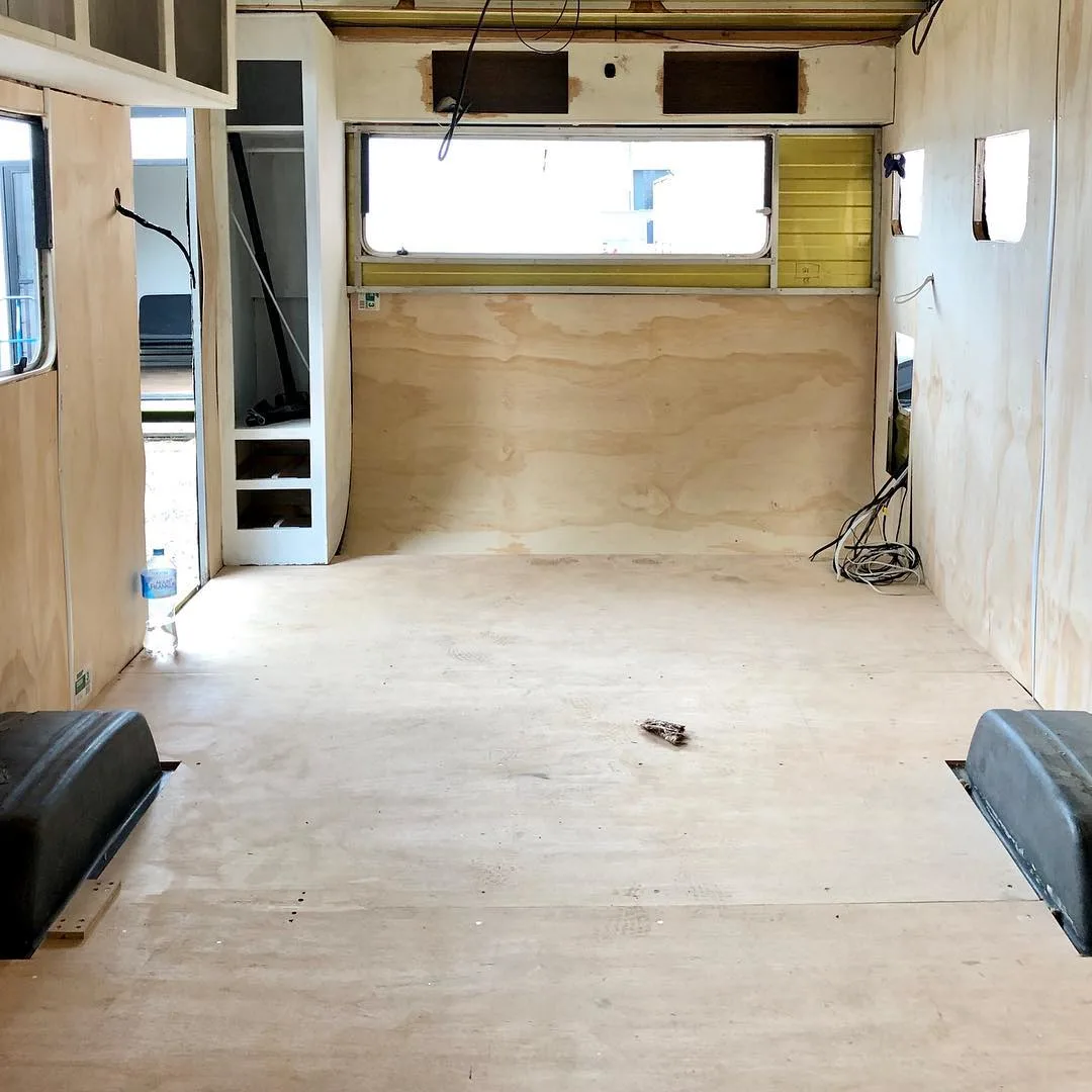 Interior of caravan mid-way through renovation with ply on the walls.
