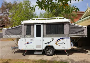 Pop up trailer extended up, ready for camping.