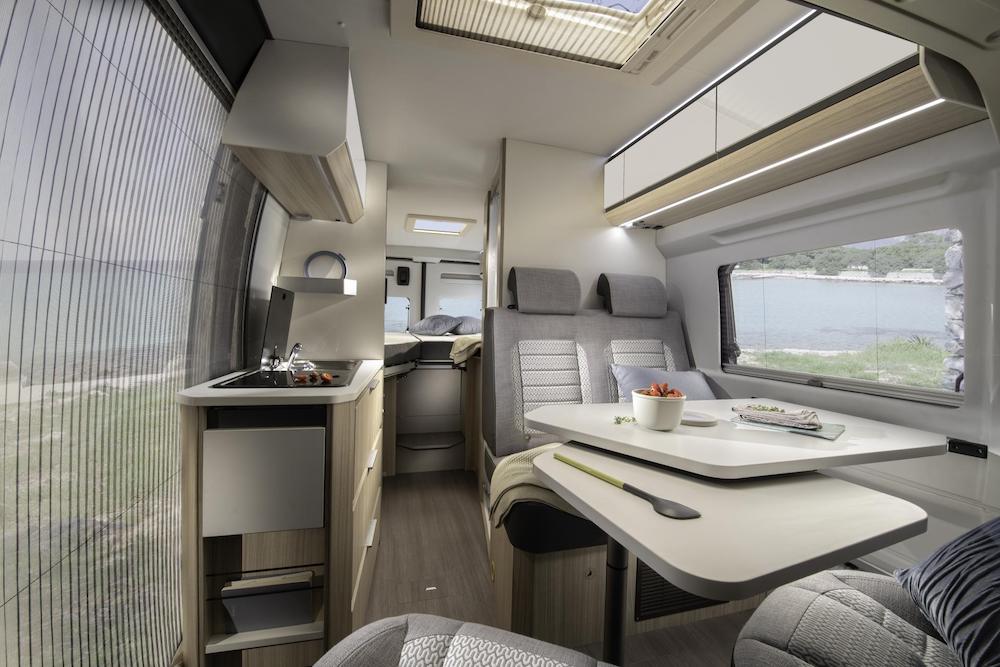 Interior view of the Adria Twin campervan looking towards the bed in the rear.