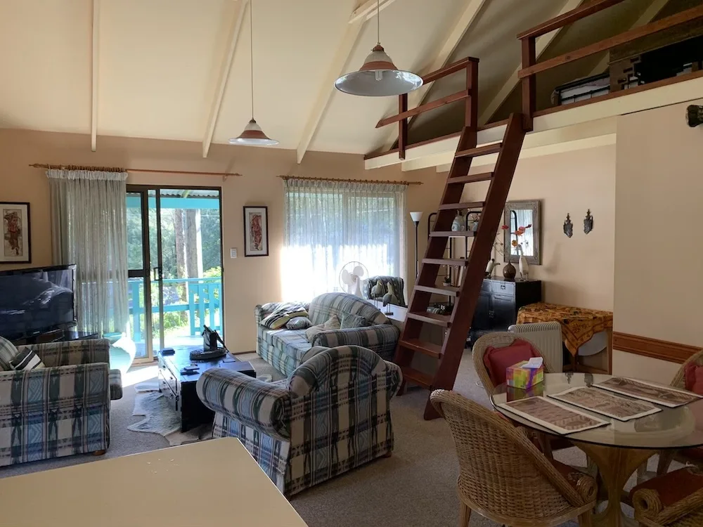 Living room of AirBnB showing lounge area with loft above