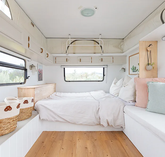 Light and white interior of a renovated vintage caravan