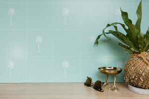 Teal coloured vinyl splashback sticker with small white palm trees