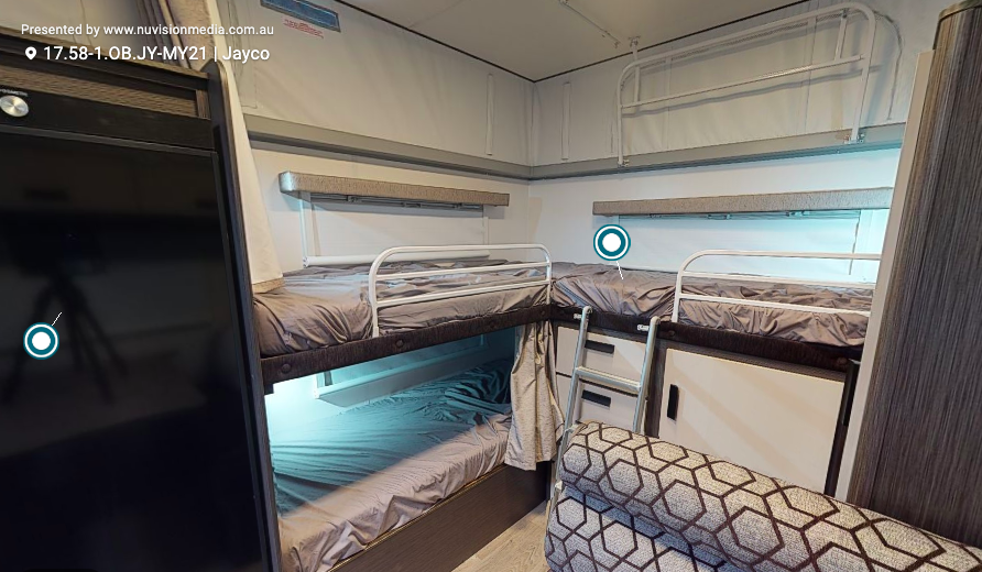 Interior of a Jayco Journey pop top caravan with bunk beds plus a single top bunk.
