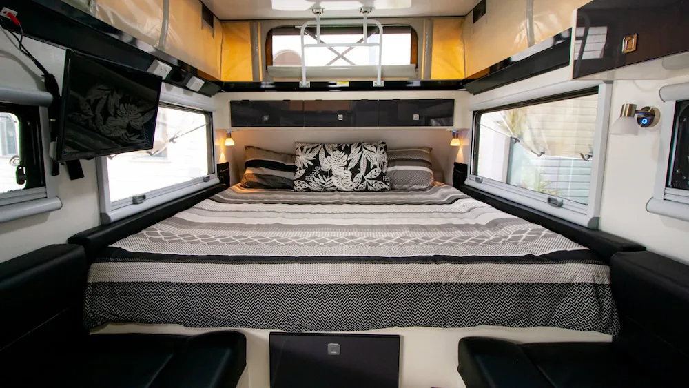 Spacious bed inside the Stoney Creek Scout 14 hybrid caravan.