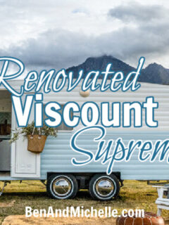 Renovated blue and white vintage caravan in a field with white lawn chairs arranged in front with text that reads: Renovated Viscount Supreme.