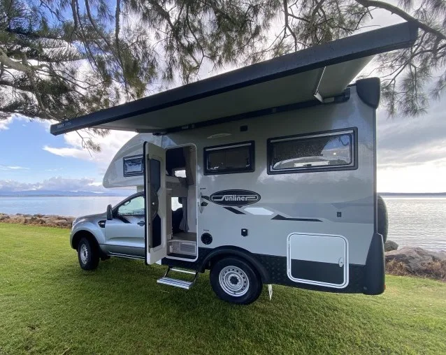 Sunliner Chase motorhome parked beside a lake.