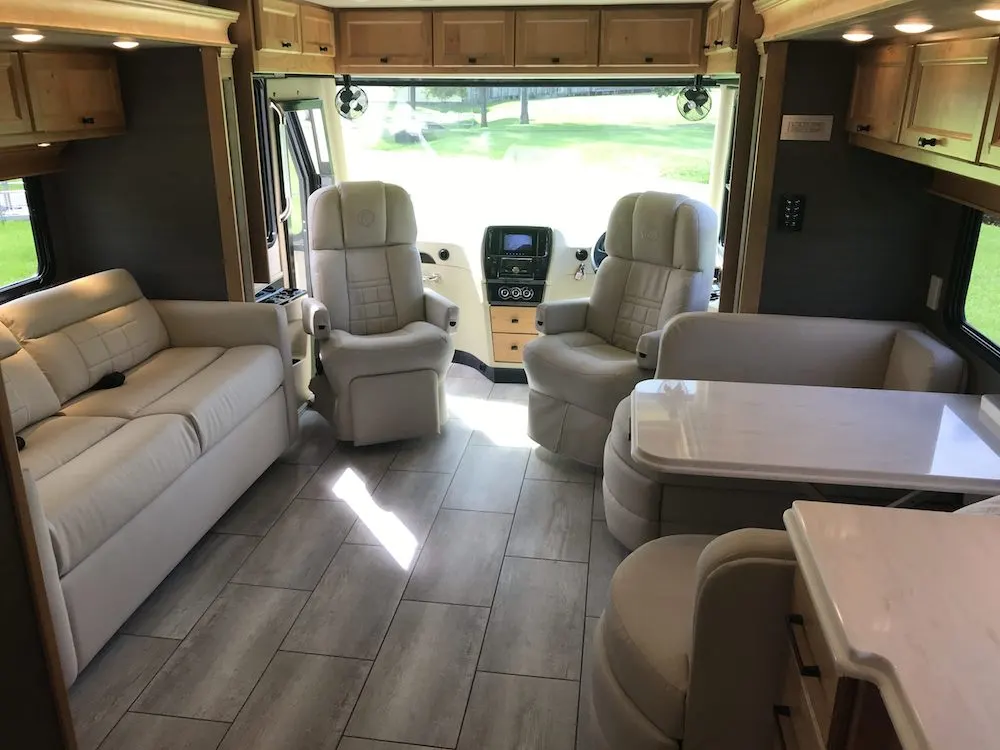 Tiffin Allegro motorhome interior looking towards the captains chairs in the front.