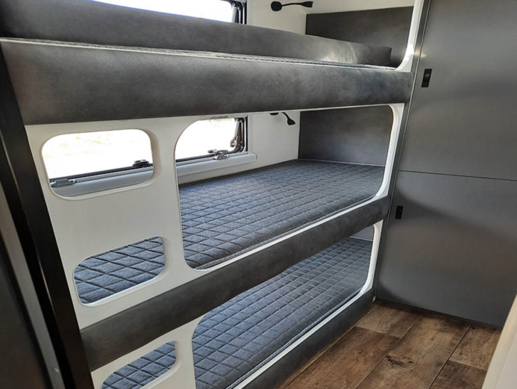 Triple bunk beds inside the Coastline family vans by Australis Caravans.