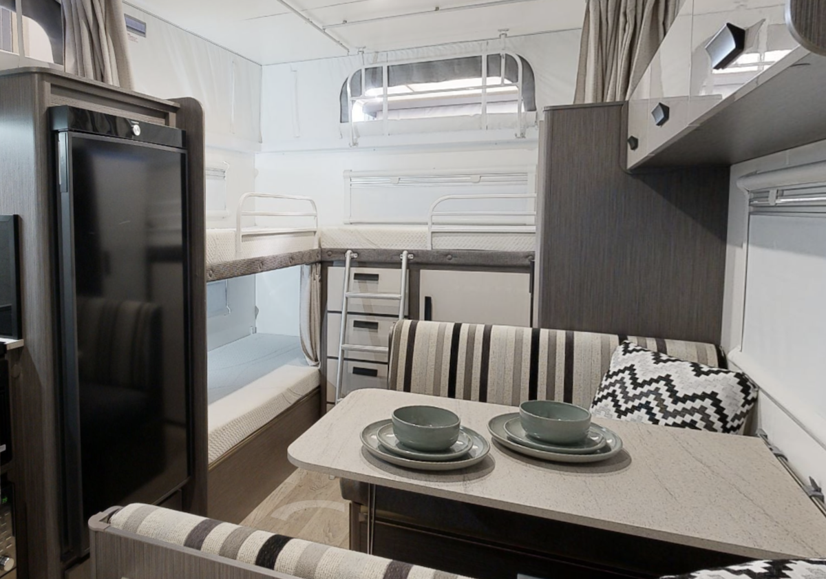 Inside of the Jayco Journey 17.58 pop top caravan showing the double bunks plus one extra bunk.