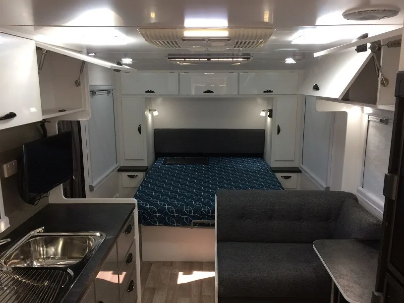 Interior view of the Sunland Blue Heeler 19'6 off road caravan showing the queen island bed.