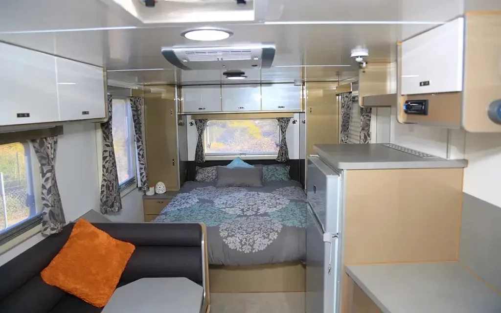 Interior view of the Trakmaster Pilbara S series off road caravan showing the queen size island bed.