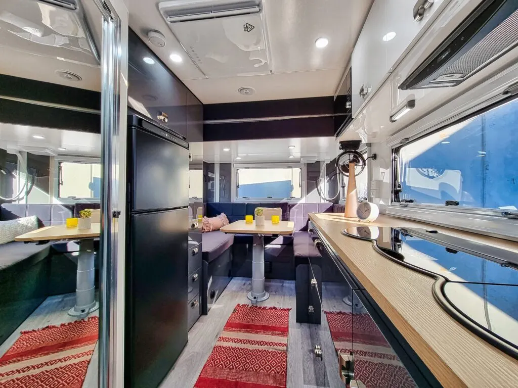 Interior of the Royal Flair Raxor XT caravan showing the drop down bed above the club lounge.